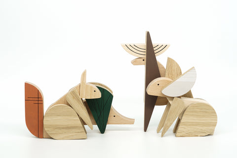 Wooden forest animal figurines on a white background